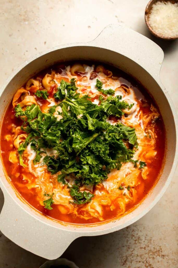 Creamy Tortellini Minestrone Soup is hearty, cozy, and loaded with veggies, beans, and cheese tortellini in a rich tomato-cream broth. | aheadofthyme.com
