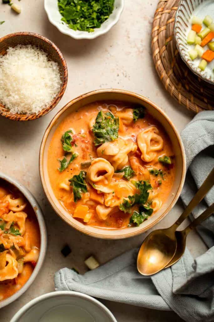 Creamy Tortellini Minestrone Soup is hearty, cozy, and loaded with veggies, beans, and cheese tortellini in a rich tomato-cream broth. | aheadofthyme.com