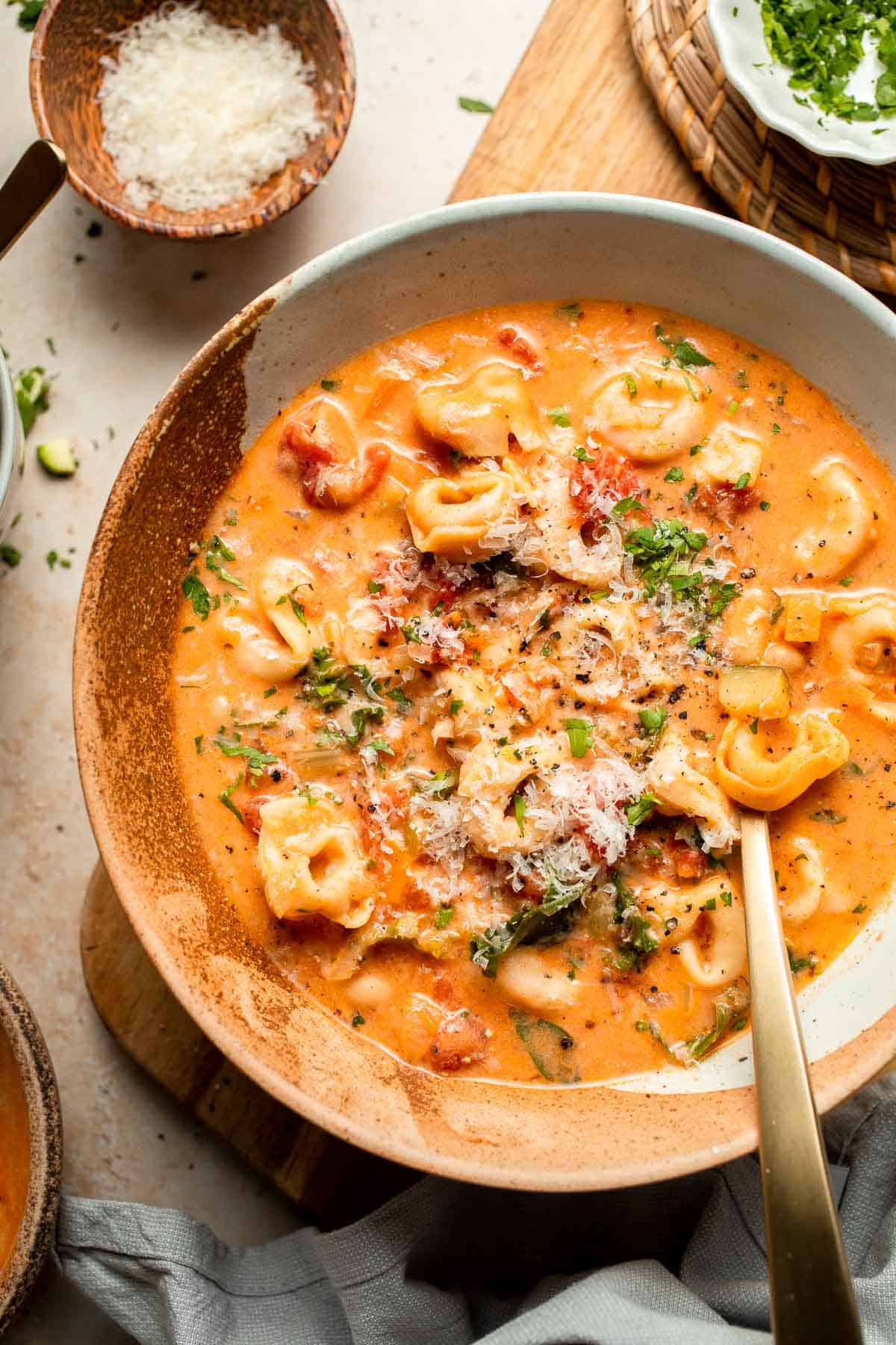 Creamy Tortellini Minestrone Soup is hearty, cozy, and loaded with veggies, beans, and cheese tortellini in a rich tomato-cream broth. | aheadofthyme.com