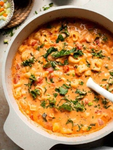 Creamy Tortellini Minestrone Soup is hearty, cozy, and loaded with veggies, beans, and cheese tortellini in a rich tomato-cream broth. | aheadofthyme.com