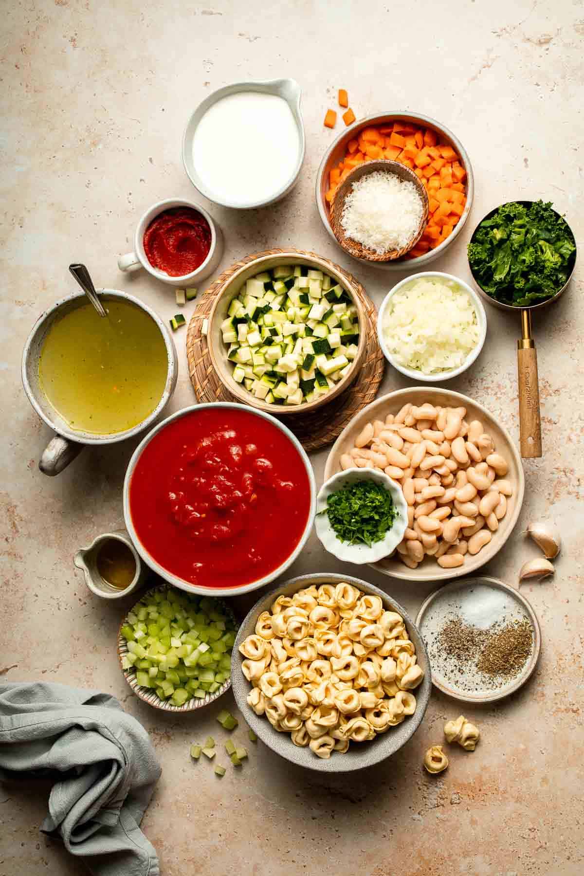 Creamy Tortellini Minestrone Soup is hearty, cozy, and loaded with veggies, beans, and cheese tortellini in a rich tomato-cream broth. | aheadofthyme.com
