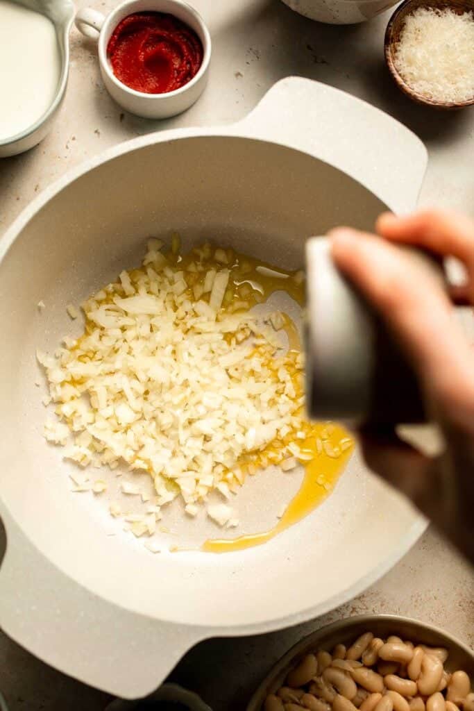 Creamy Tortellini Minestrone Soup is hearty, cozy, and loaded with veggies, beans, and cheese tortellini in a rich tomato-cream broth. | aheadofthyme.com