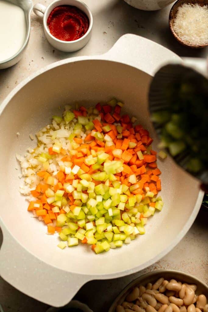 Creamy Tortellini Minestrone Soup is hearty, cozy, and loaded with veggies, beans, and cheese tortellini in a rich tomato-cream broth. | aheadofthyme.com