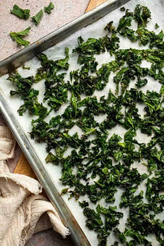 Crispy roasted kale made with olive oil, garlic, and parmesan. A quick and healthy side dish that bakes into perfectly crunchy, flavorful pieces. | aheadofthyme.com