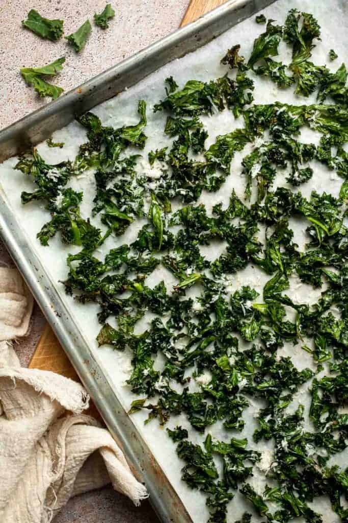 Crispy roasted kale made with olive oil, garlic, and parmesan. A quick and healthy side dish that bakes into perfectly crunchy, flavorful pieces. | aheadofthyme.com