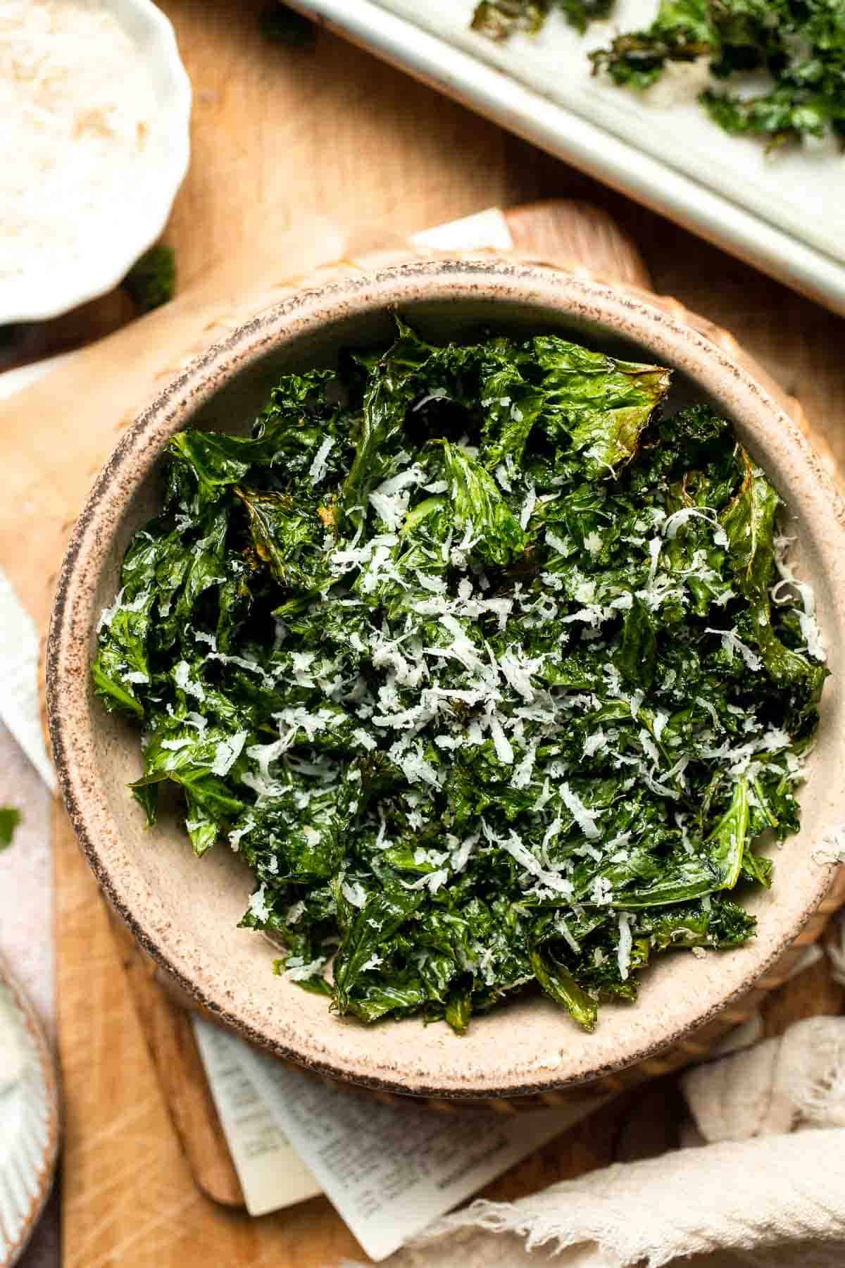 Crispy roasted kale made with olive oil, garlic, and parmesan. A quick and healthy side dish that bakes into perfectly crunchy, flavorful pieces. | aheadofthyme.com
