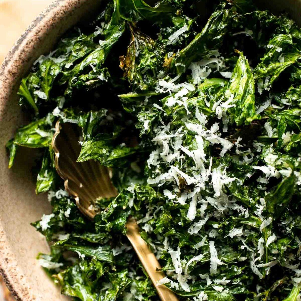 Crispy roasted kale made with olive oil, garlic, and parmesan. A quick and healthy side dish that bakes into perfectly crunchy, flavorful pieces. | aheadofthyme.com