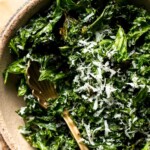Crispy roasted kale made with olive oil, garlic, and parmesan. A quick and healthy side dish that bakes into perfectly crunchy, flavorful pieces. | aheadofthyme.com