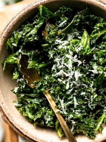 Crispy roasted kale made with olive oil, garlic, and parmesan. A quick and healthy side dish that bakes into perfectly crunchy, flavorful pieces. | aheadofthyme.com