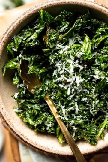 Crispy roasted kale made with olive oil, garlic, and parmesan. A quick and healthy side dish that bakes into perfectly crunchy, flavorful pieces. | aheadofthyme.com