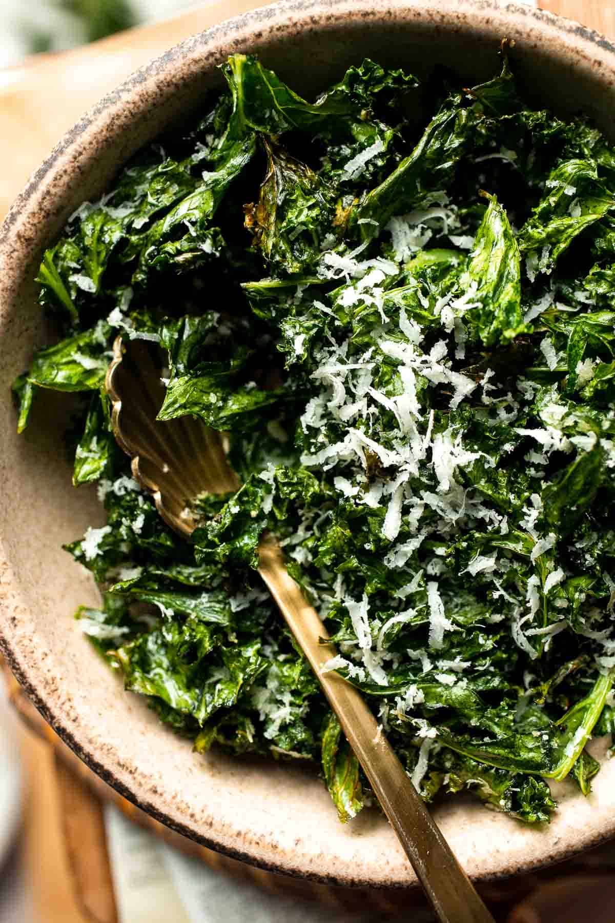 Crispy roasted kale made with olive oil, garlic, and parmesan. A quick and healthy side dish that bakes into perfectly crunchy, flavorful pieces. | aheadofthyme.com