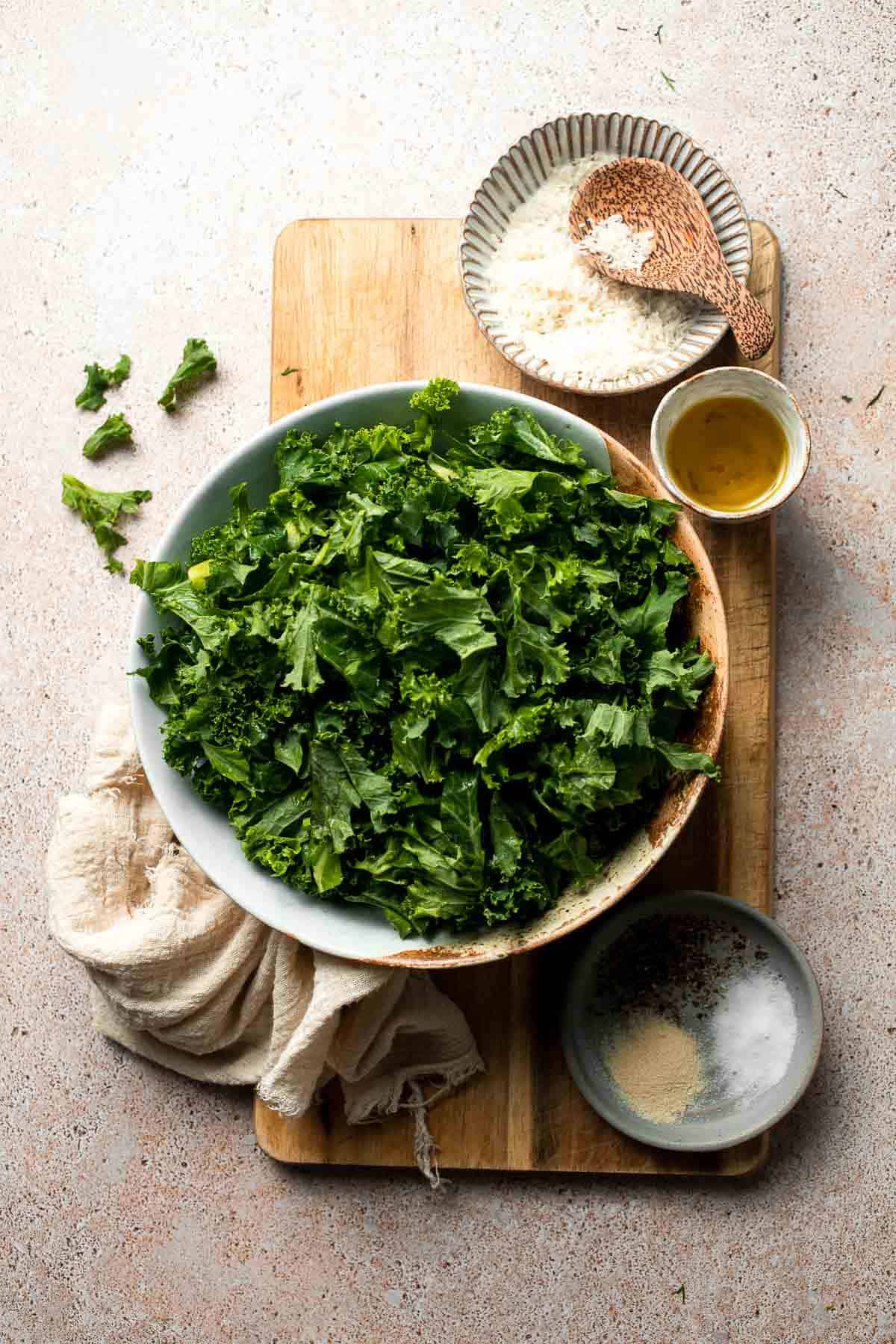 Crispy roasted kale made with olive oil, garlic, and parmesan. A quick and healthy side dish that bakes into perfectly crunchy, flavorful pieces. | aheadofthyme.com