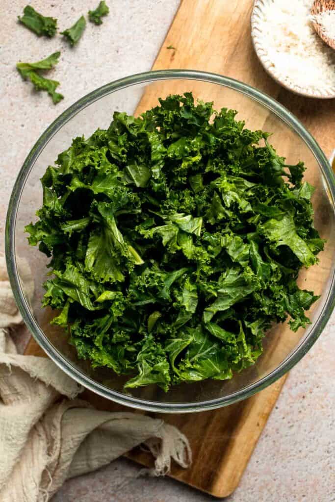 Crispy roasted kale made with olive oil, garlic, and parmesan. A quick and healthy side dish that bakes into perfectly crunchy, flavorful pieces. | aheadofthyme.com