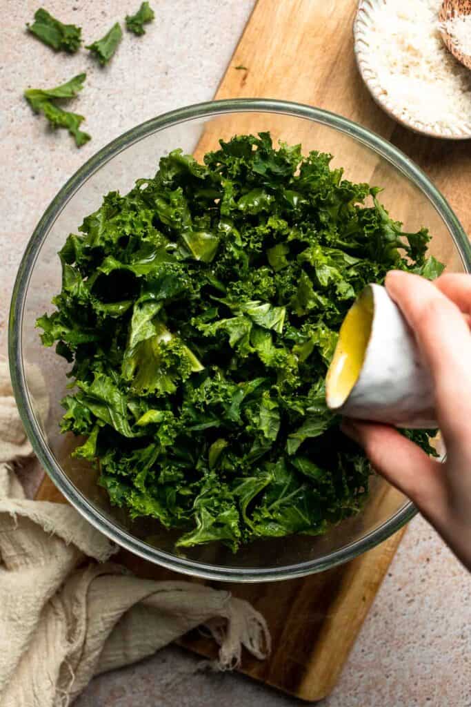 Crispy roasted kale made with olive oil, garlic, and parmesan. A quick and healthy side dish that bakes into perfectly crunchy, flavorful pieces. | aheadofthyme.com