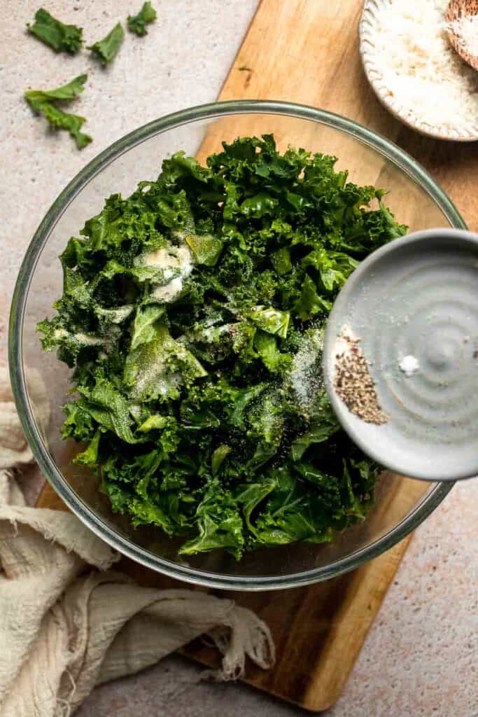 Crispy roasted kale made with olive oil, garlic, and parmesan. A quick and healthy side dish that bakes into perfectly crunchy, flavorful pieces. | aheadofthyme.com