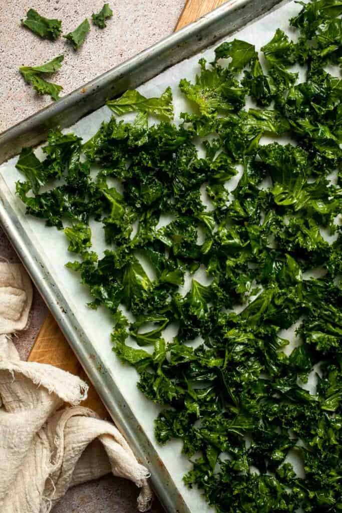 Crispy roasted kale made with olive oil, garlic, and parmesan. A quick and healthy side dish that bakes into perfectly crunchy, flavorful pieces. | aheadofthyme.com