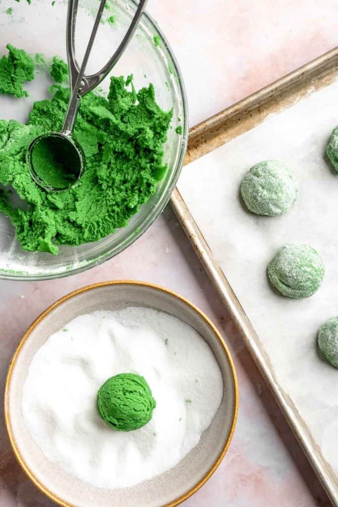 Grinch Cookies are soft, chewy green sugar cookies rolled in sparkly sugar and topped with a red heart. The cutest Christmas cookies for holiday baking. | aheadofthyme.com