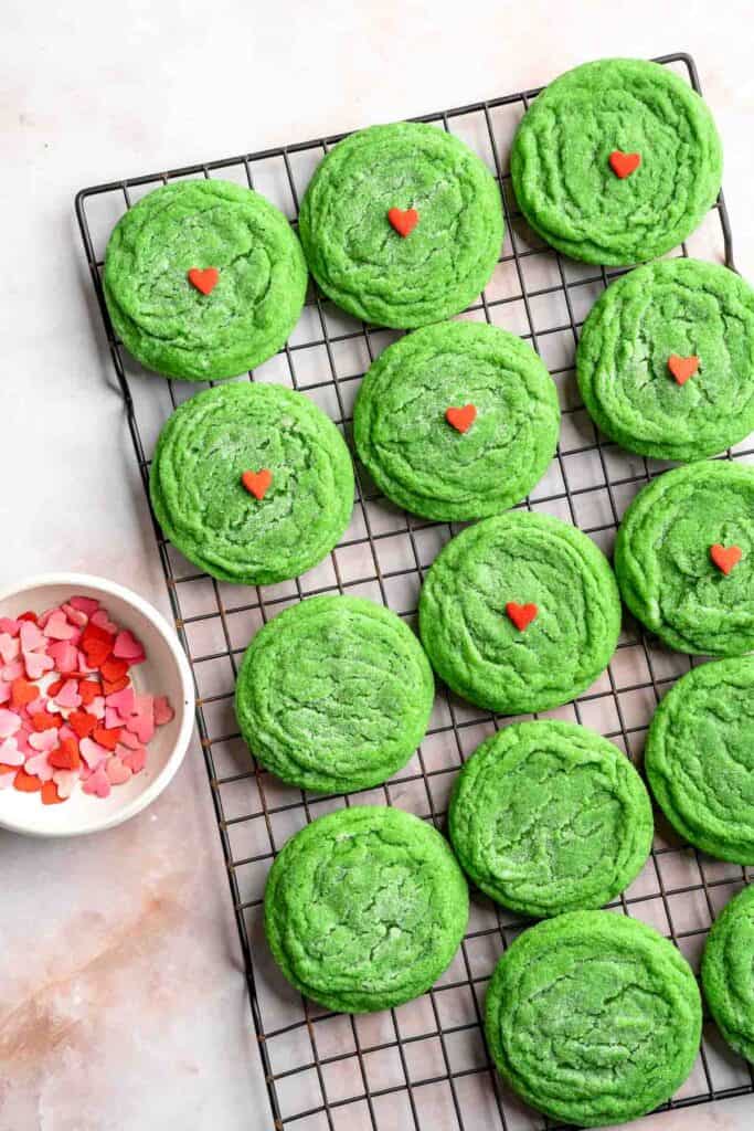Grinch Cookies are soft, chewy green sugar cookies rolled in sparkly sugar and topped with a red heart. The cutest Christmas cookies for holiday baking. | aheadofthyme.com