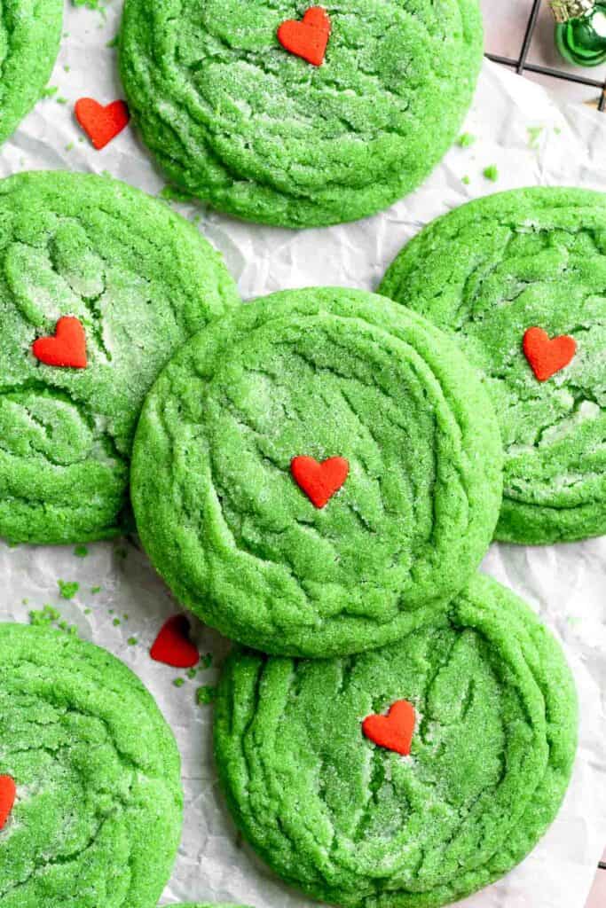 Grinch Cookies are soft, chewy green sugar cookies rolled in sparkly sugar and topped with a red heart. The cutest Christmas cookies for holiday baking. | aheadofthyme.com