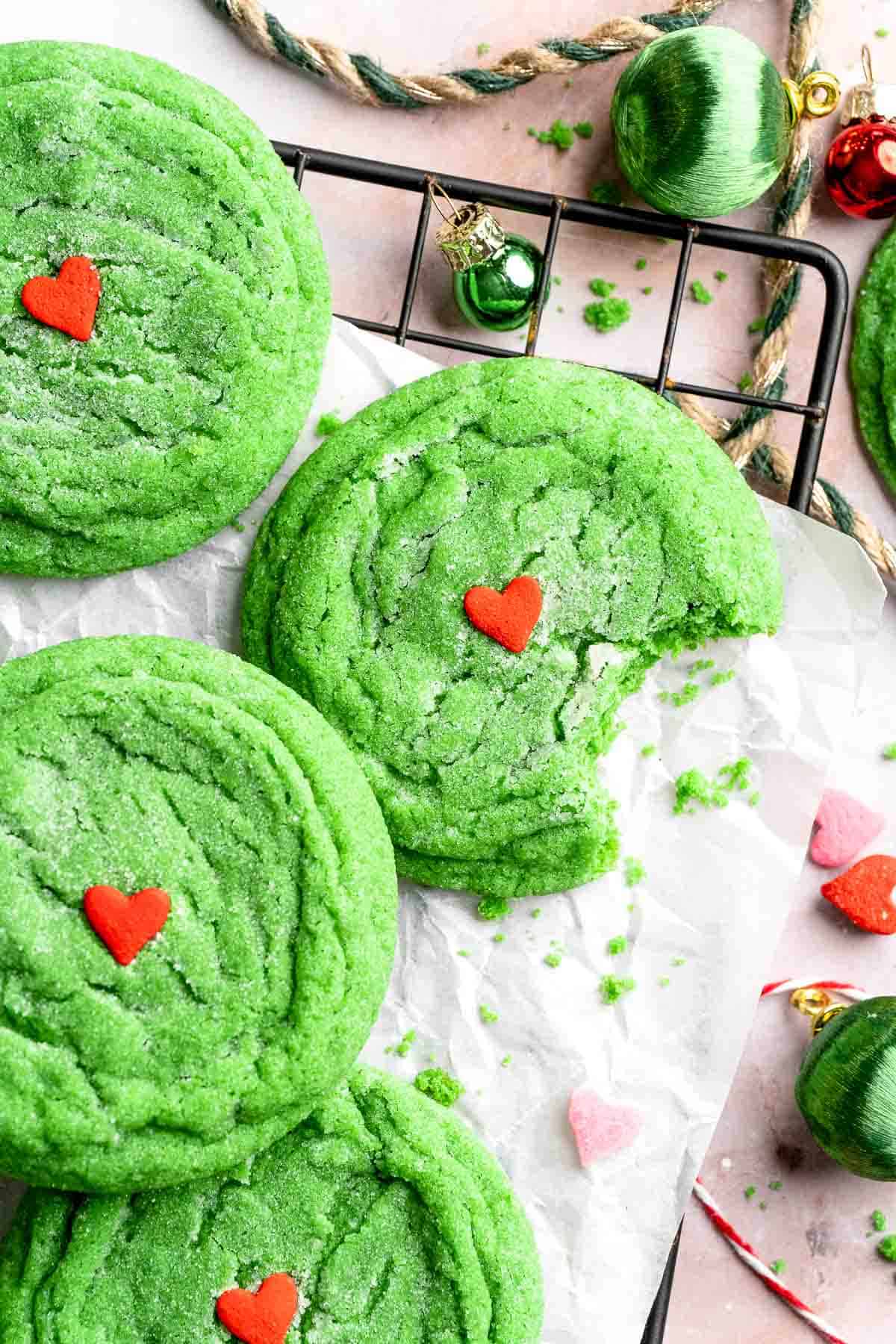 Grinch Cookies are soft, chewy green sugar cookies rolled in sparkly sugar and topped with a red heart. The cutest Christmas cookies for holiday baking. | aheadofthyme.com