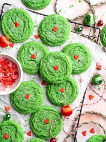 Grinch Cookies are soft, chewy green sugar cookies rolled in sparkly sugar and topped with a red heart. The cutest Christmas cookies for holiday baking. | aheadofthyme.com
