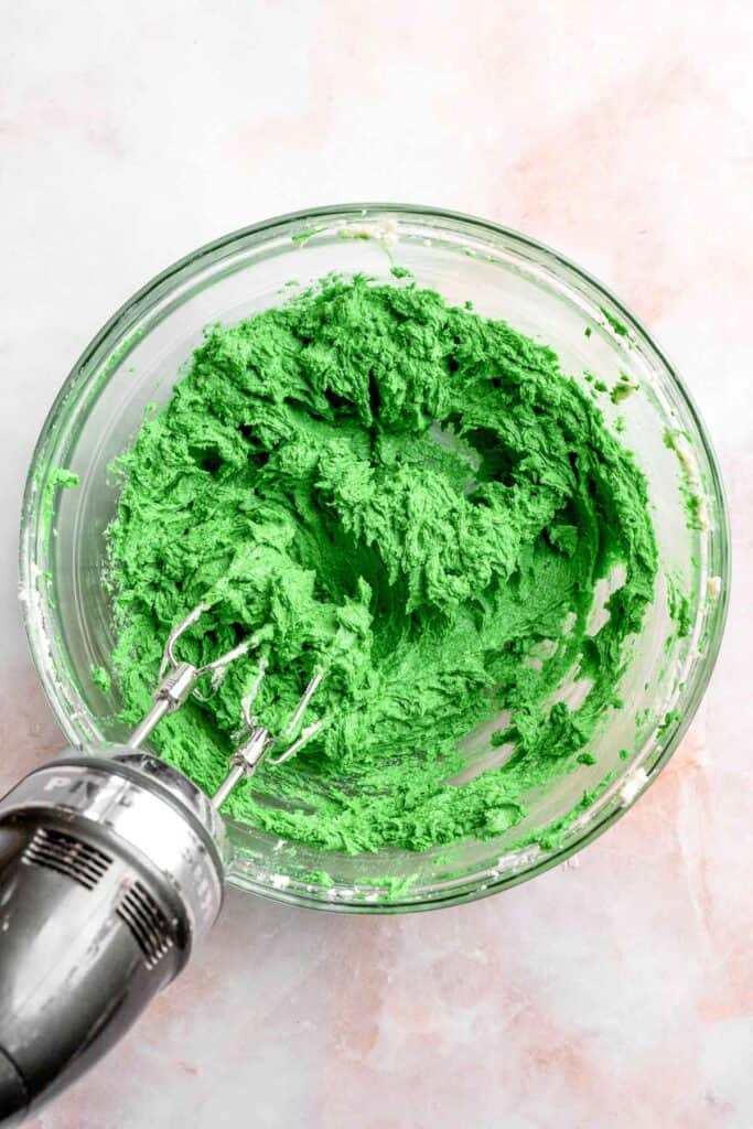 Grinch Cookies are soft, chewy green sugar cookies rolled in sparkly sugar and topped with a red heart. The cutest Christmas cookies for holiday baking. | aheadofthyme.com