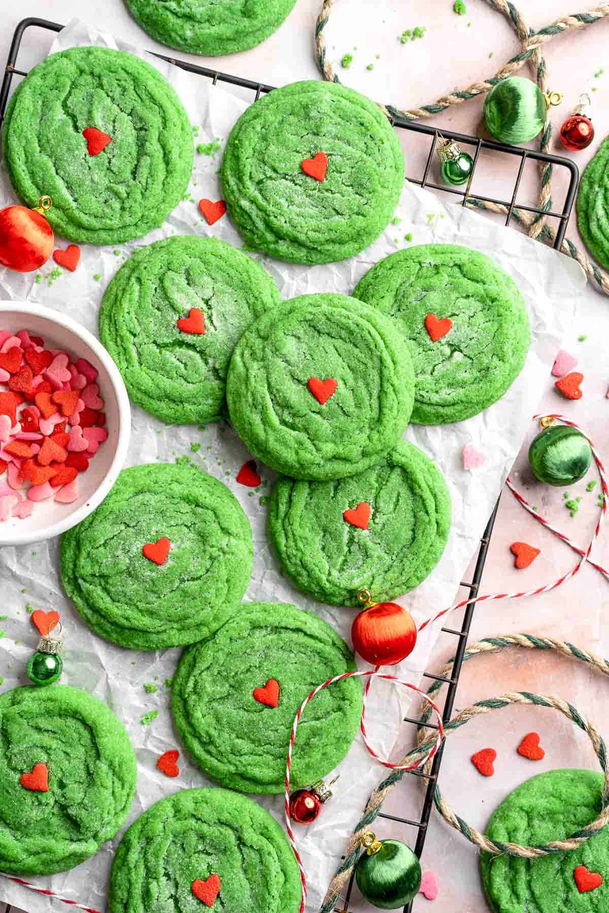 Grinch Cookies are soft, chewy green sugar cookies rolled in sparkly sugar and topped with a red heart. The cutest Christmas cookies for holiday baking. | aheadofthyme.com