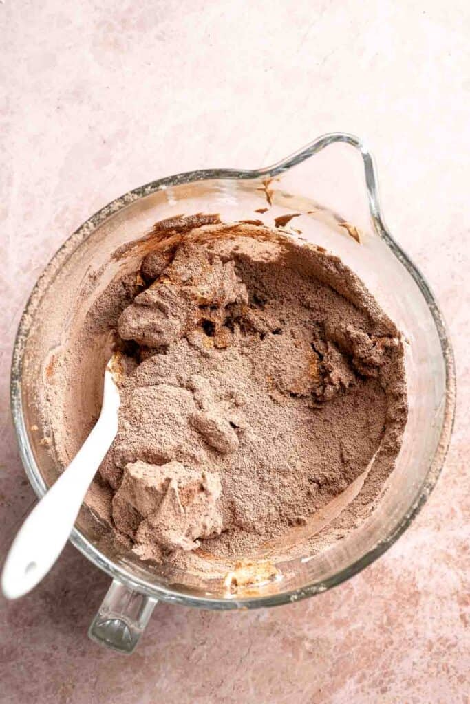 Hot chocolate macarons with cocoa shells and fluffy marshmallow filling. A cozy winter treat perfect for holiday baking and festive cookie trays. | aheadofthyme.com