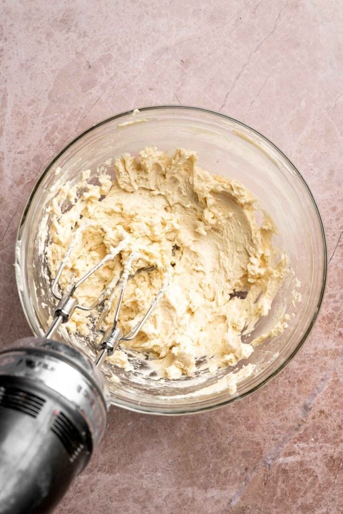 Hot chocolate macarons with cocoa shells and fluffy marshmallow filling. A cozy winter treat perfect for holiday baking and festive cookie trays. | aheadofthyme.com