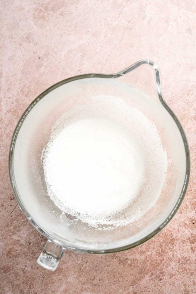 Hot chocolate macarons with cocoa shells and fluffy marshmallow filling. A cozy winter treat perfect for holiday baking and festive cookie trays. | aheadofthyme.com