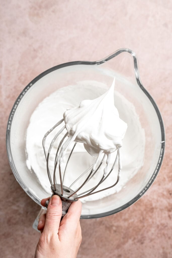 Hot chocolate macarons with cocoa shells and fluffy marshmallow filling. A cozy winter treat perfect for holiday baking and festive cookie trays. | aheadofthyme.com