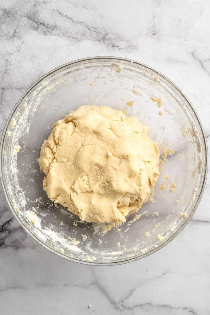 Peppermint pinwheel cookies with red, green, and white swirled dough rolled in festive sprinkles. A fun slice and bake Christmas cookie. | aheadofthyme.com