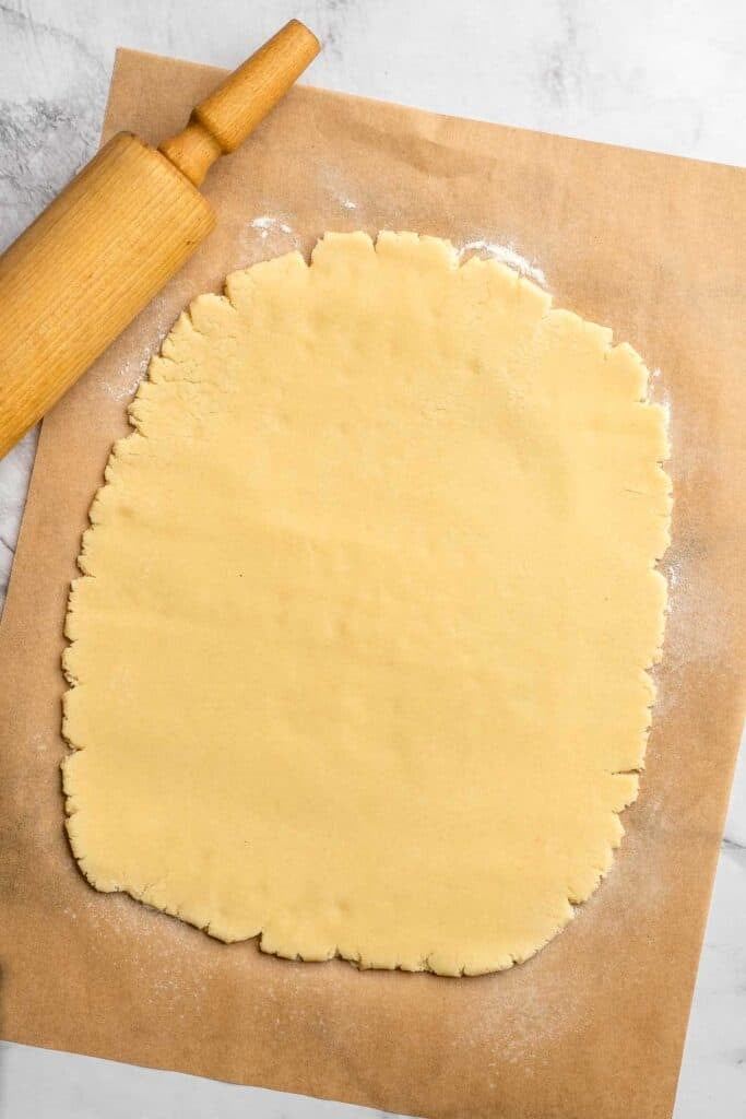 Peppermint pinwheel cookies with red, green, and white swirled dough rolled in festive sprinkles. A fun slice and bake Christmas cookie. | aheadofthyme.com