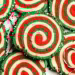 Peppermint pinwheel cookies with red, green, and white swirled dough rolled in festive sprinkles. A fun slice and bake Christmas cookie. | aheadofthyme.com