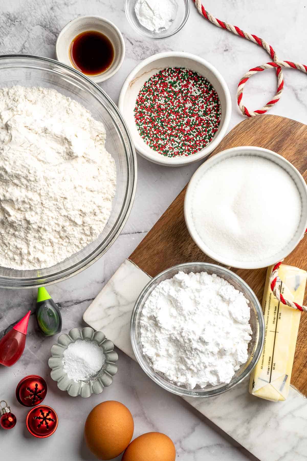 Peppermint pinwheel cookies with red, green, and white swirled dough rolled in festive sprinkles. A fun slice and bake Christmas cookie. | aheadofthyme.com