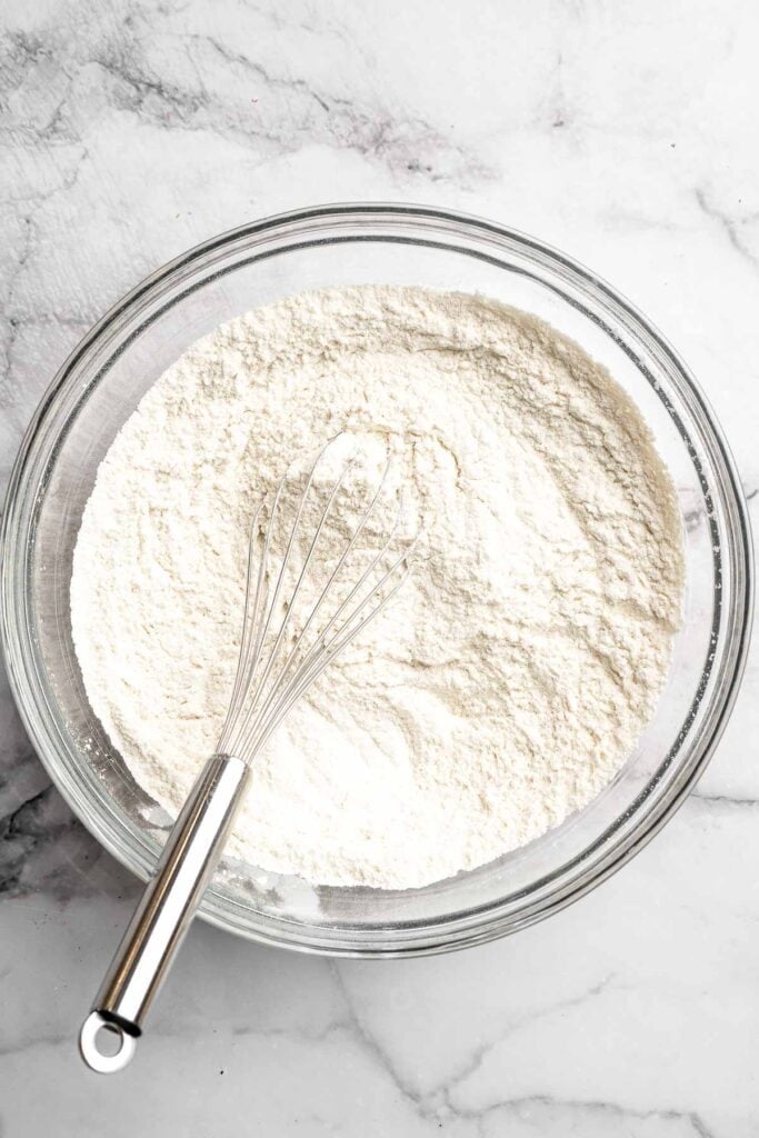 Peppermint pinwheel cookies with red, green, and white swirled dough rolled in festive sprinkles. A fun slice and bake Christmas cookie. | aheadofthyme.com