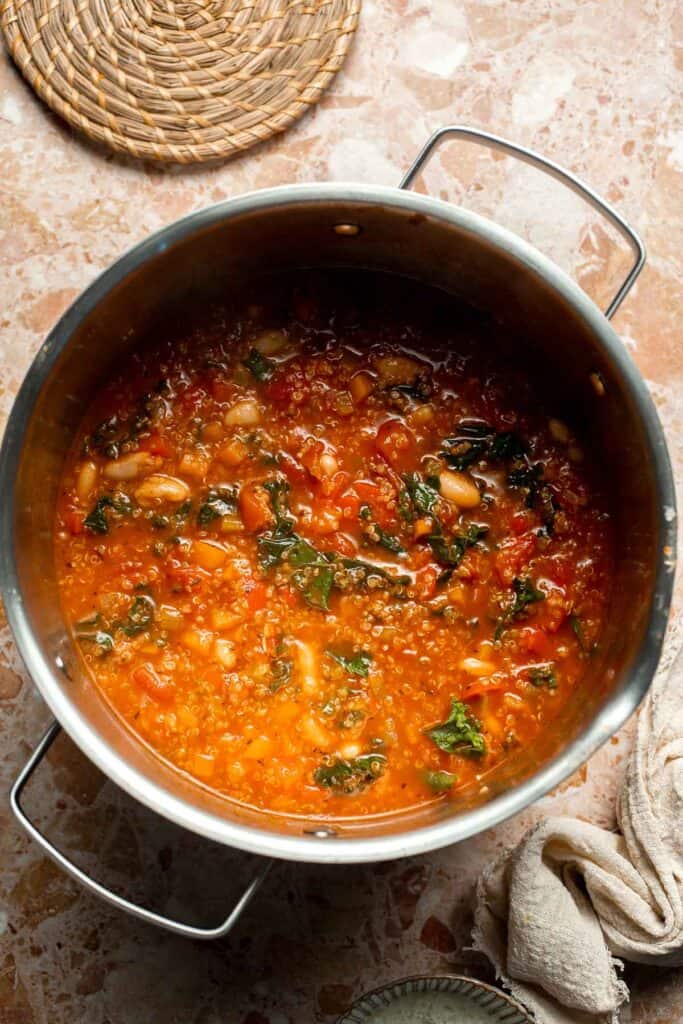 Hearty quinoa vegetable soup with tomatoes, beans, and kale. Healthy, cozy, and easy to make in one pot for a nourishing meal. | aheadofthyme.com