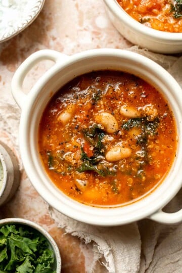 Hearty quinoa vegetable soup with tomatoes, beans, and kale. Healthy, cozy, and easy to make in one pot for a nourishing meal. | aheadofthyme.com