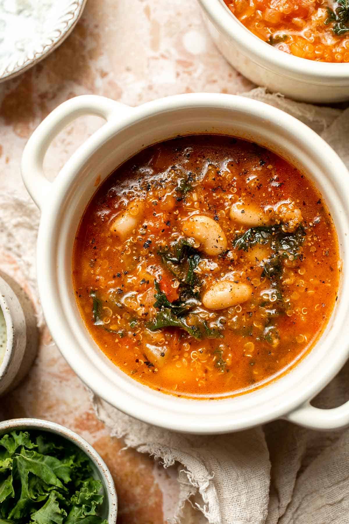 Hearty quinoa vegetable soup with tomatoes, beans, and kale. Healthy, cozy, and easy to make in one pot for a nourishing meal. | aheadofthyme.com