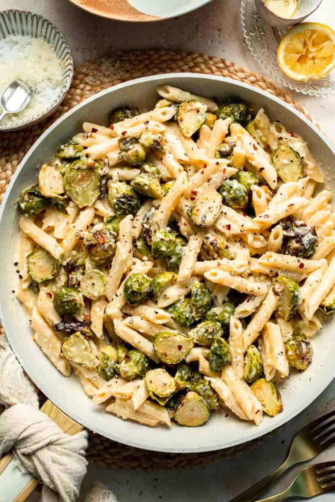 Roasted Brussels Sprouts Pasta is creamy, cozy, and full of caramelized sprouts tossed in a garlic Parmesan sauce. A delicious and easy weeknight dinner. | aheadofthyme.com