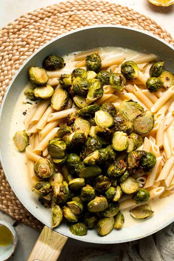 Roasted Brussels Sprouts Pasta is creamy, cozy, and full of caramelized sprouts tossed in a garlic Parmesan sauce. A delicious and easy weeknight dinner. | aheadofthyme.com