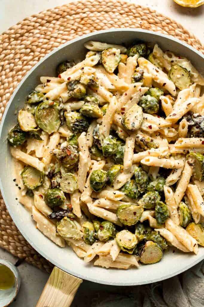 Roasted Brussels Sprouts Pasta is creamy, cozy, and full of caramelized sprouts tossed in a garlic Parmesan sauce. A delicious and easy weeknight dinner. | aheadofthyme.com