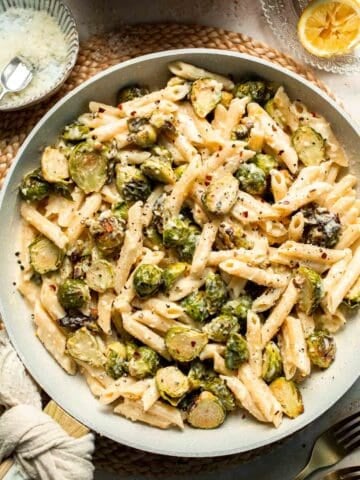 Roasted Brussels Sprouts Pasta is creamy, cozy, and full of caramelized sprouts tossed in a garlic Parmesan sauce. A delicious and easy weeknight dinner. | aheadofthyme.com
