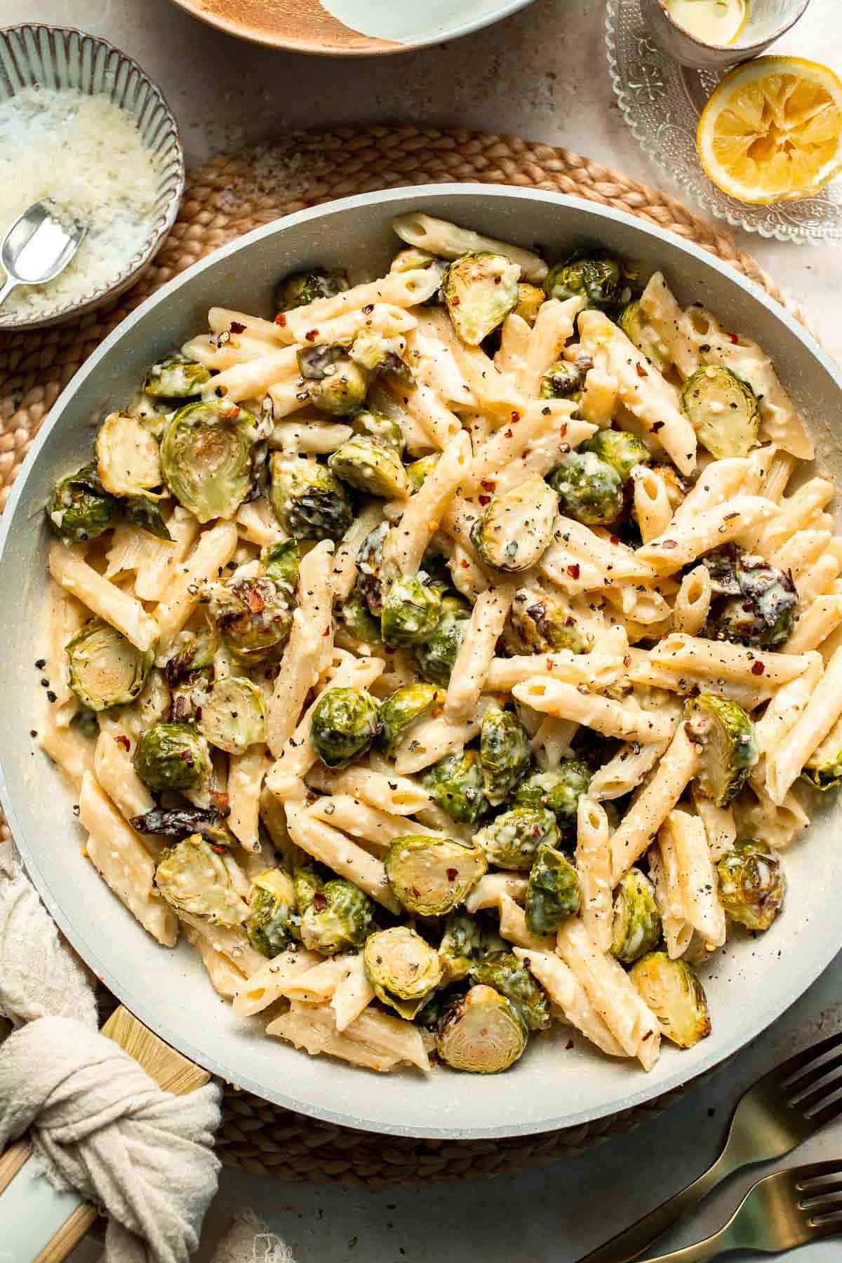 Roasted Brussels Sprouts Pasta is creamy, cozy, and full of caramelized sprouts tossed in a garlic Parmesan sauce. A delicious and easy weeknight dinner. | aheadofthyme.com