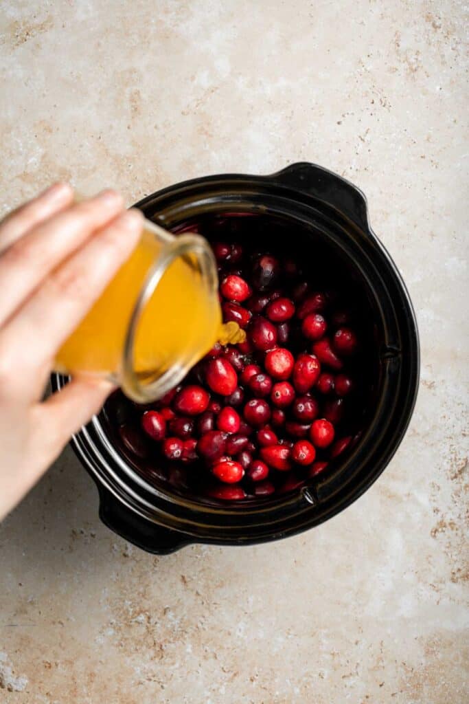 This slow cooker cranberry sauce is sweet, tart, and perfectly spiced. Make this easy cranberry sauce in the crockpot for a stress-free holiday side. | aheadofthyme.com