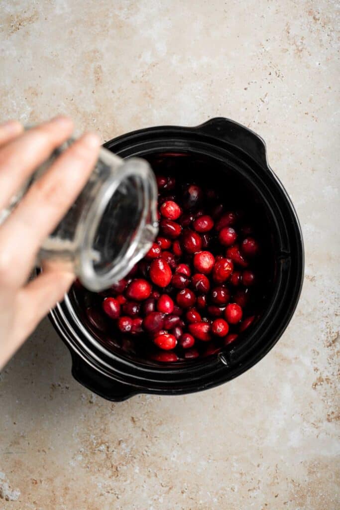 This slow cooker cranberry sauce is sweet, tart, and perfectly spiced. Make this easy cranberry sauce in the crockpot for a stress-free holiday side. | aheadofthyme.com