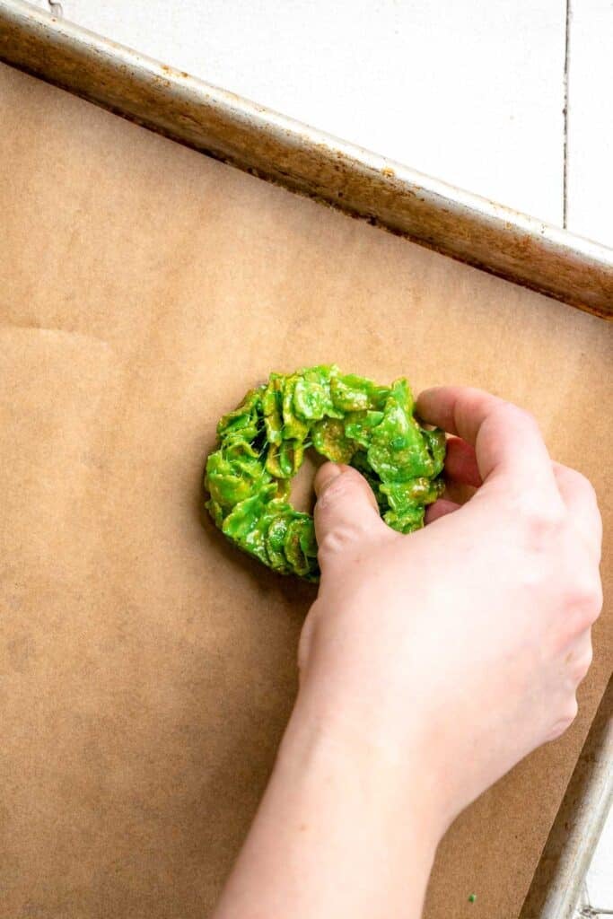 Easy no bake Cornflake Christmas Wreath Cookies made with marshmallows, butter, and green food coloring. They're fun, festive holiday treats everyone loves! | aheadofthyme.com