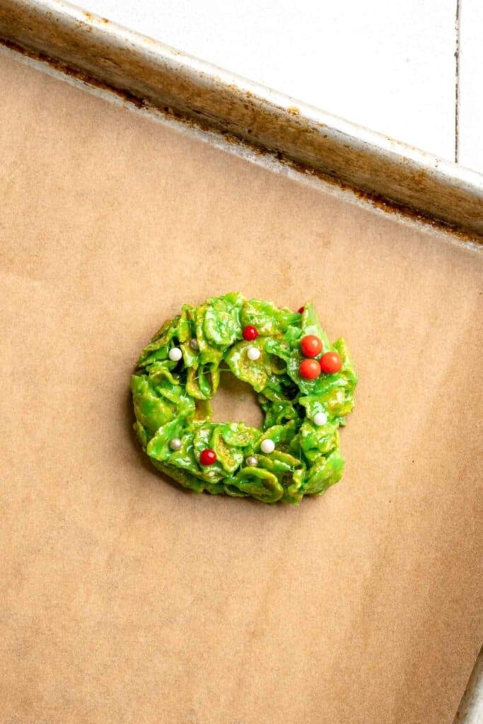 Easy no bake Cornflake Christmas Wreath Cookies made with marshmallows, butter, and green food coloring. They're fun, festive holiday treats everyone loves! | aheadofthyme.com