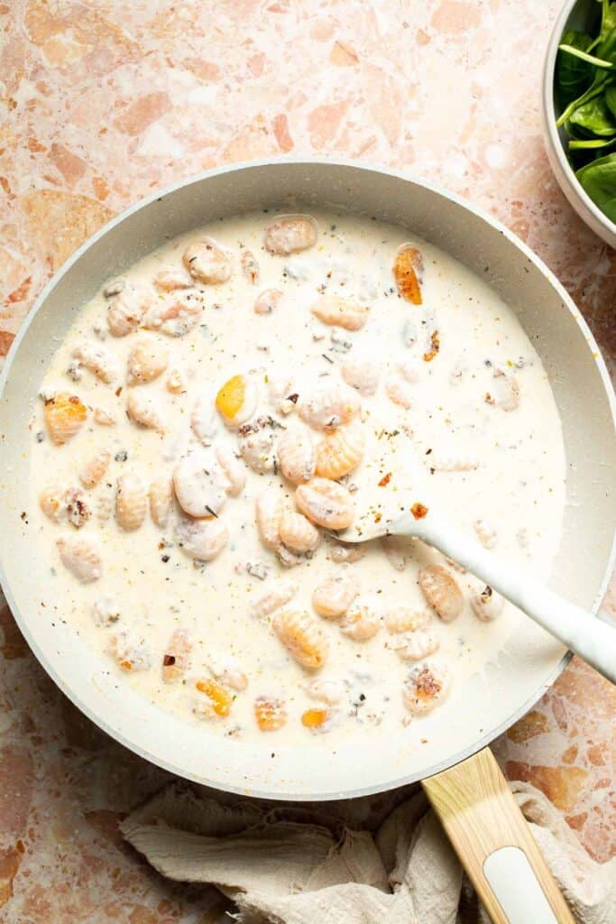 This creamy Tuscan gnocchi is a quick one pan dinner with sun dried tomatoes, spinach, garlic, and Parmesan. | aheadofthyme.com