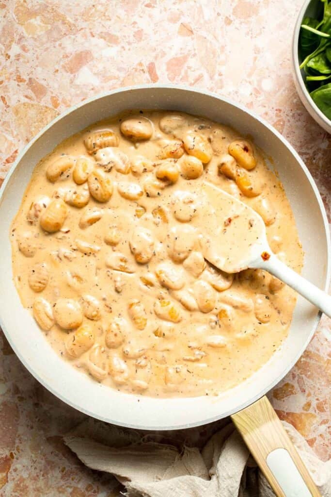 This creamy Tuscan gnocchi is a quick one pan dinner with sun dried tomatoes, spinach, garlic, and Parmesan. | aheadofthyme.com